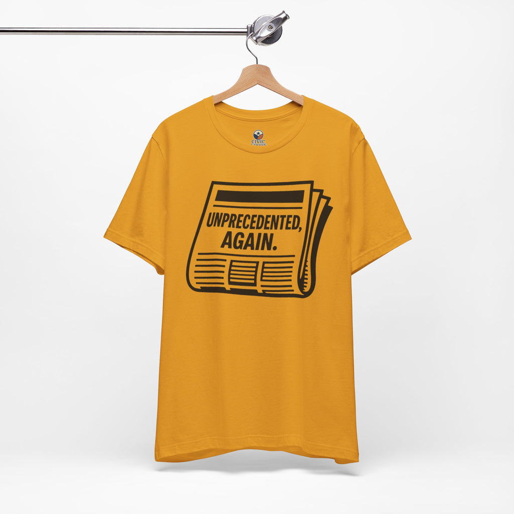 Unprecedented Again tee— Mustard  - accent — angled hanging
